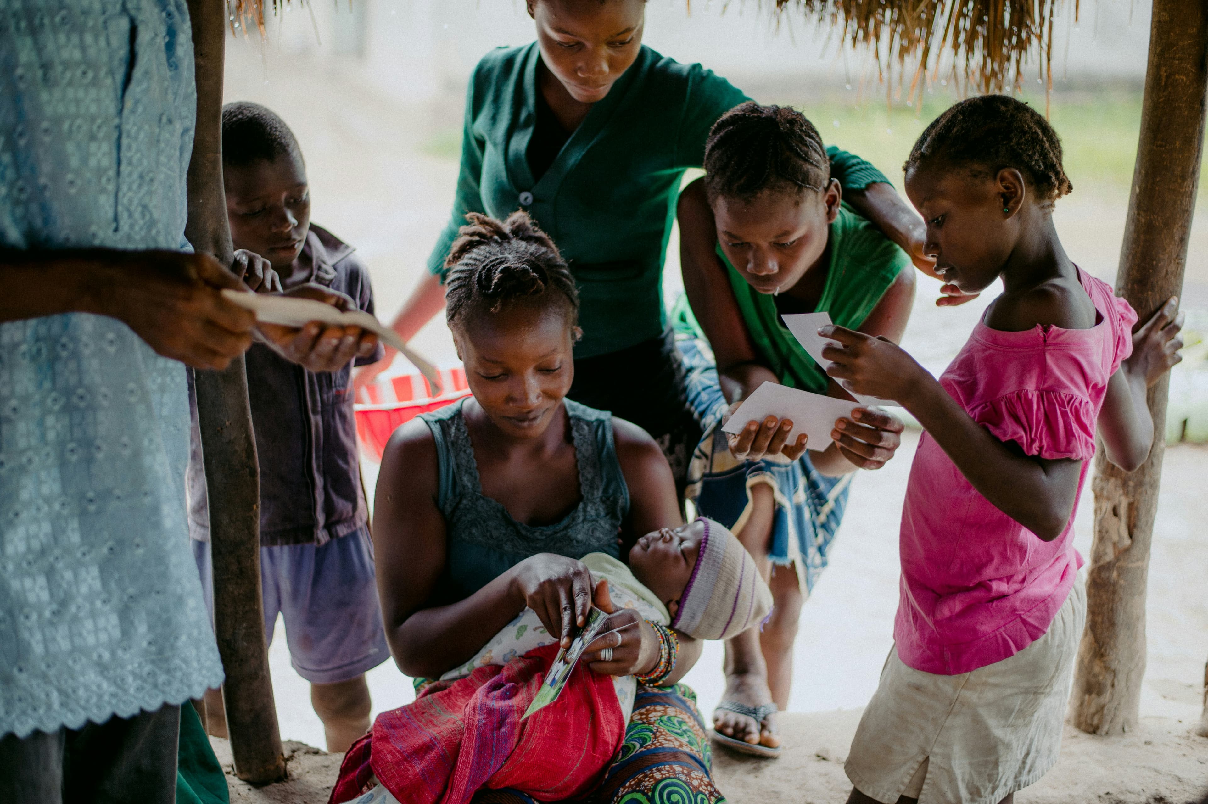 A mother holds her young child with warmth and care, representing the human story behind early childhood rights in Uganda.
