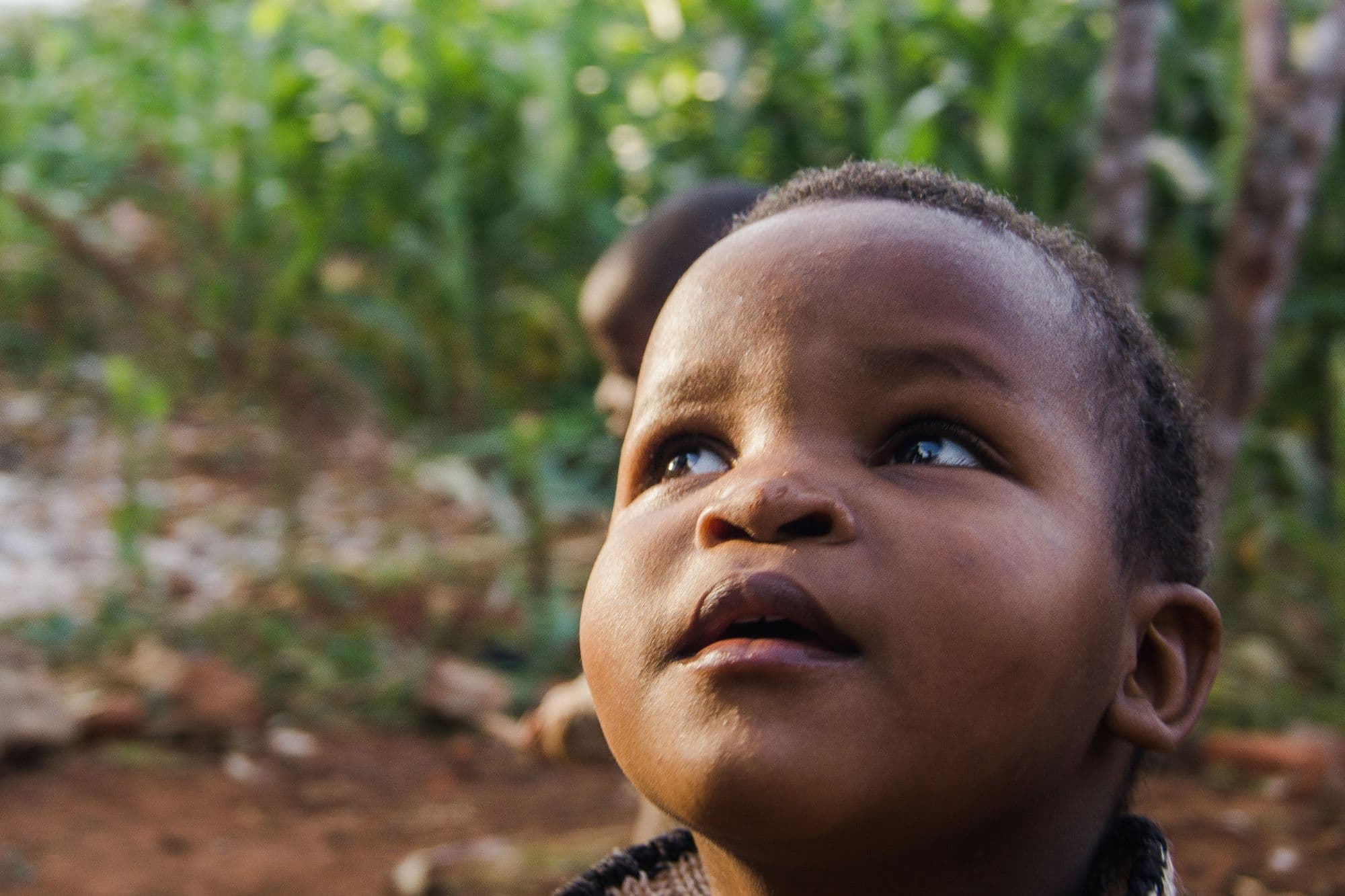 Young child looking up with hope, Uganda