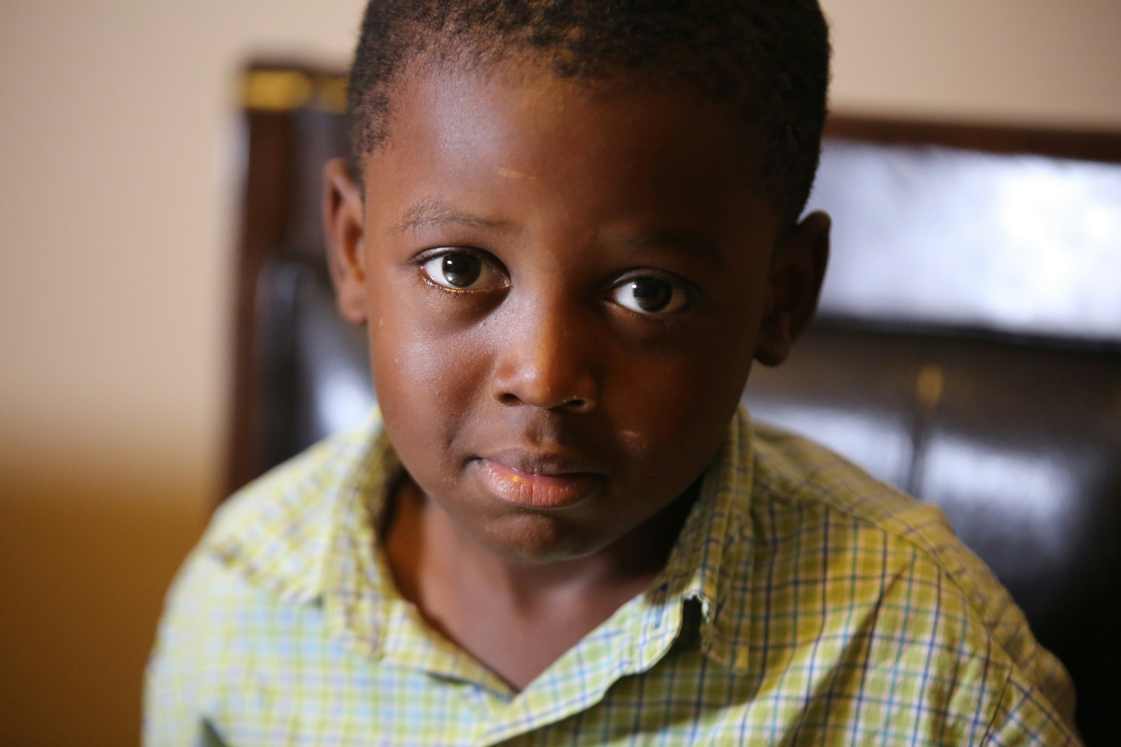 A young African child, representing the subject at the heart of early childhood legal mapping and rights analysis.